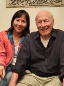 Author and journal founder sitting side by side, smiling at the camera.